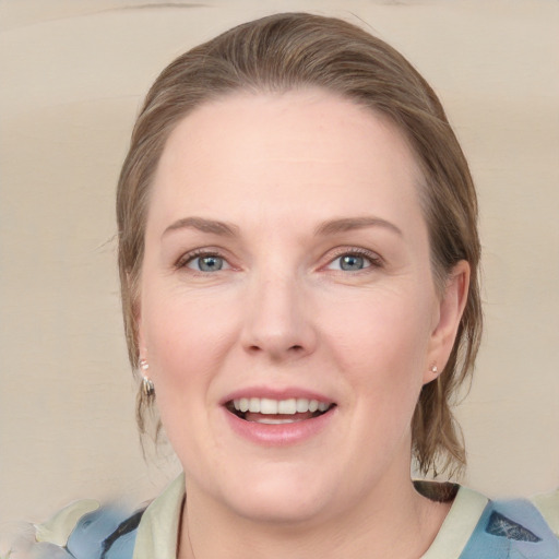 Joyful white young-adult female with medium  brown hair and blue eyes