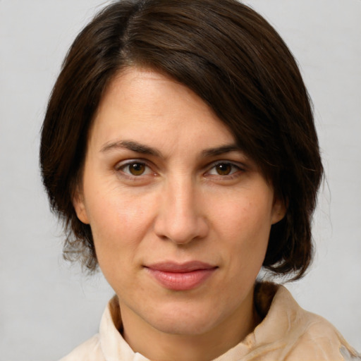 Joyful white adult female with medium  brown hair and brown eyes