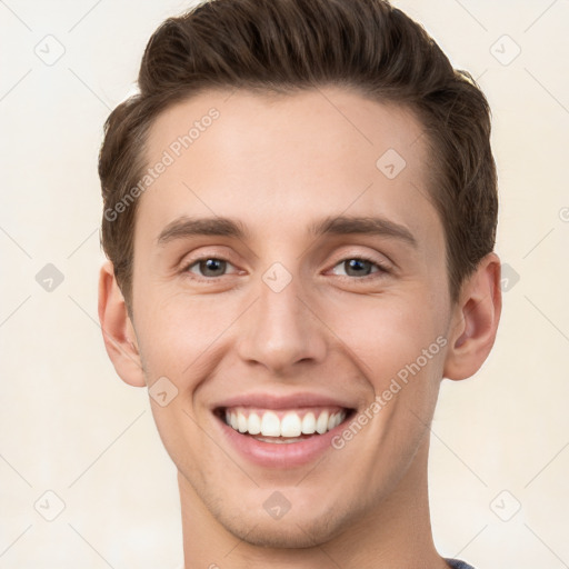 Joyful white young-adult male with short  brown hair and grey eyes