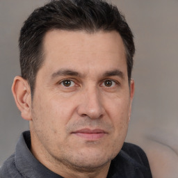 Joyful white adult male with short  brown hair and brown eyes