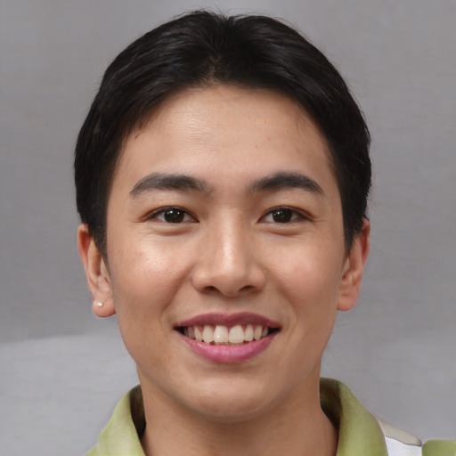 Joyful asian young-adult male with short  brown hair and brown eyes
