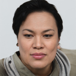 Joyful asian adult female with short  brown hair and brown eyes