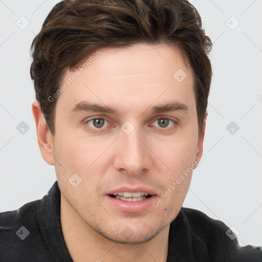 Joyful white young-adult male with short  brown hair and grey eyes