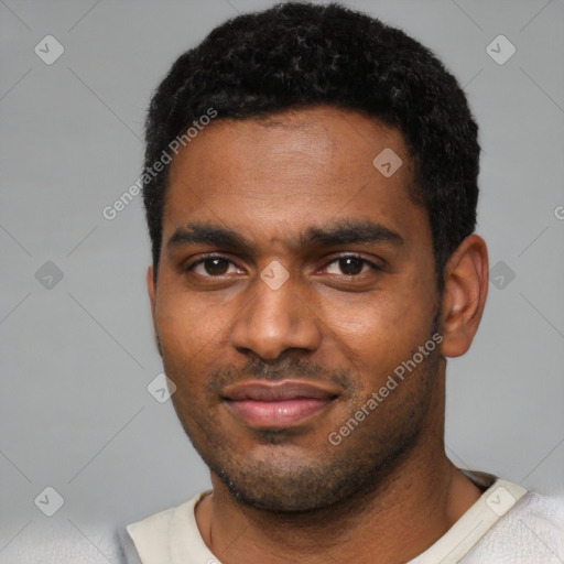 Joyful black young-adult male with short  black hair and brown eyes