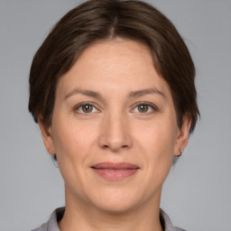 Joyful white adult female with short  brown hair and grey eyes