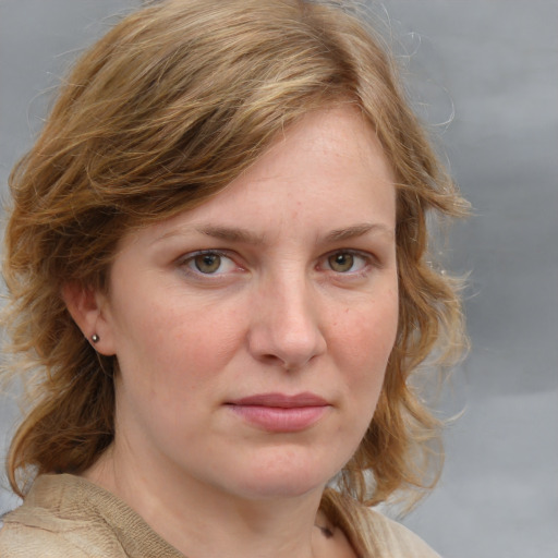 Joyful white young-adult female with medium  brown hair and blue eyes