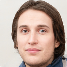 Joyful white young-adult male with medium  brown hair and grey eyes