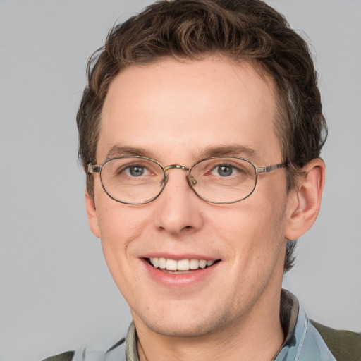 Joyful white adult male with short  brown hair and grey eyes