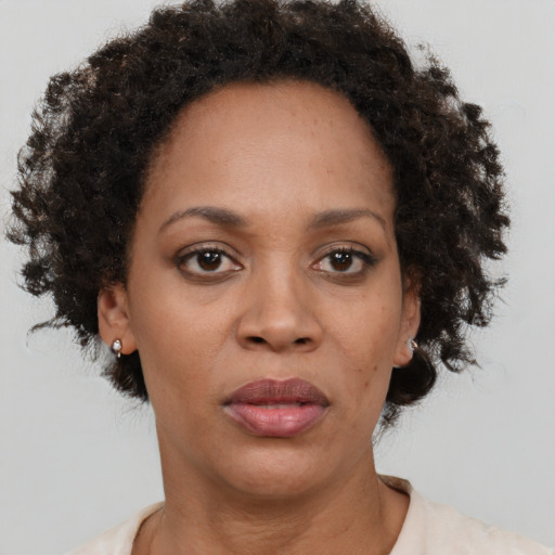 Joyful black adult female with short  brown hair and brown eyes
