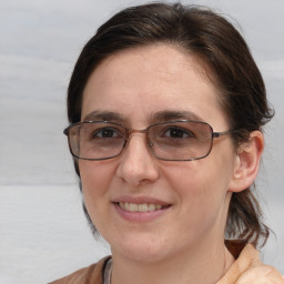 Joyful white adult female with medium  brown hair and brown eyes