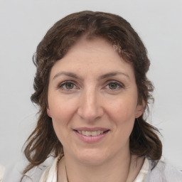 Joyful white adult female with medium  brown hair and grey eyes