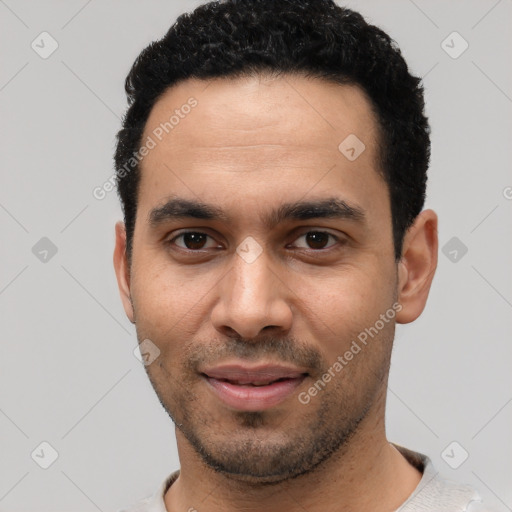 Joyful latino young-adult male with short  black hair and brown eyes