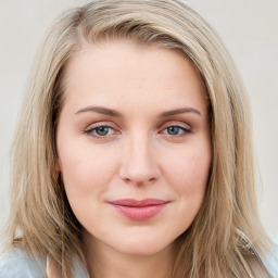 Joyful white young-adult female with long  brown hair and blue eyes