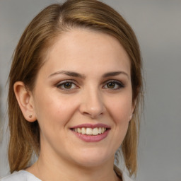 Joyful white young-adult female with medium  brown hair and brown eyes