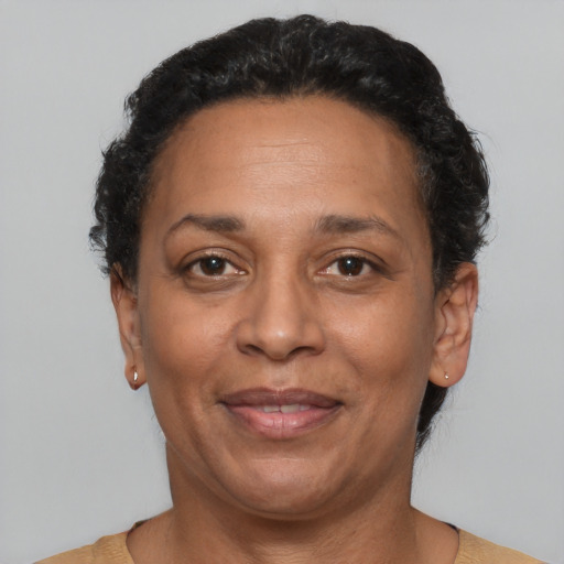 Joyful latino adult female with short  brown hair and brown eyes