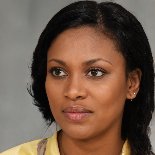 Joyful black young-adult female with medium  black hair and brown eyes