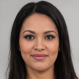 Joyful latino young-adult female with long  brown hair and brown eyes