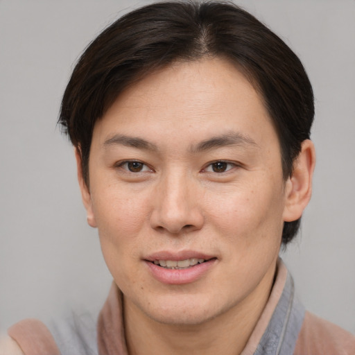 Joyful asian young-adult female with short  brown hair and brown eyes