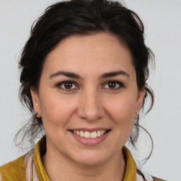 Joyful white young-adult female with medium  brown hair and brown eyes