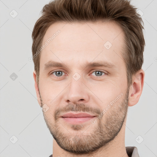 Joyful white young-adult male with short  brown hair and grey eyes