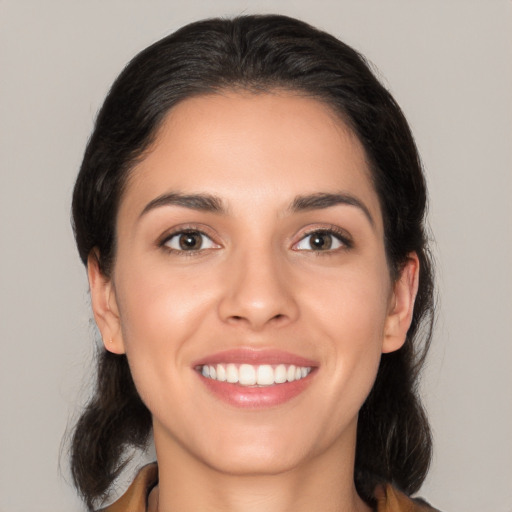 Joyful white young-adult female with medium  black hair and brown eyes