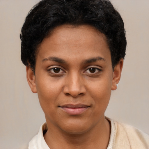 Joyful black young-adult female with short  brown hair and brown eyes