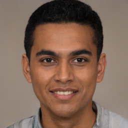 Joyful latino young-adult male with short  black hair and brown eyes