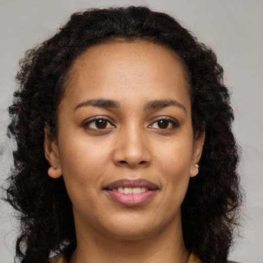 Joyful latino young-adult female with long  brown hair and brown eyes