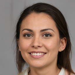 Joyful white young-adult female with medium  brown hair and brown eyes