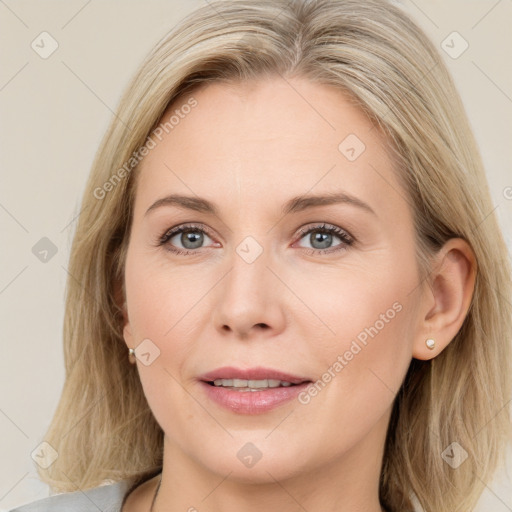 Joyful white adult female with medium  brown hair and blue eyes