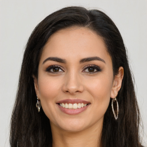 Joyful latino young-adult female with long  brown hair and brown eyes