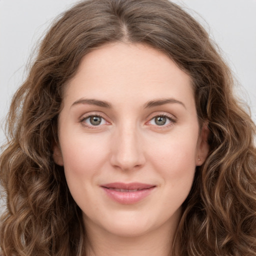 Joyful white young-adult female with long  brown hair and green eyes