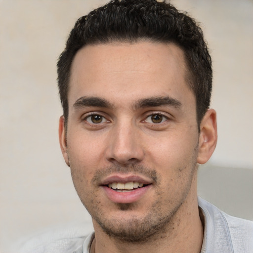 Joyful white young-adult male with short  black hair and brown eyes