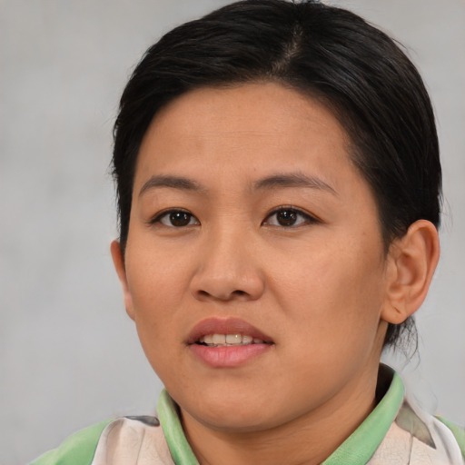 Joyful asian young-adult female with short  brown hair and brown eyes
