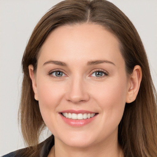 Joyful white young-adult female with long  brown hair and grey eyes