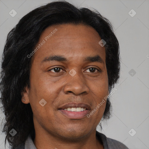 Joyful black adult male with short  brown hair and brown eyes