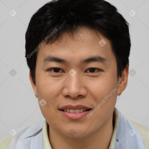 Joyful asian young-adult male with short  brown hair and brown eyes