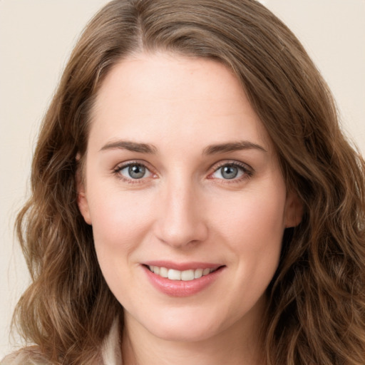 Joyful white young-adult female with long  brown hair and green eyes