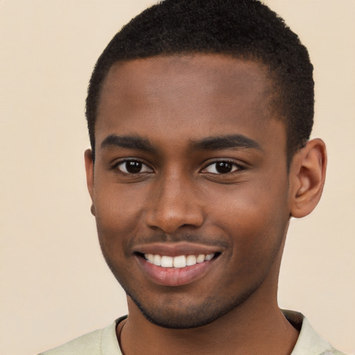 Joyful black young-adult male with short  brown hair and brown eyes