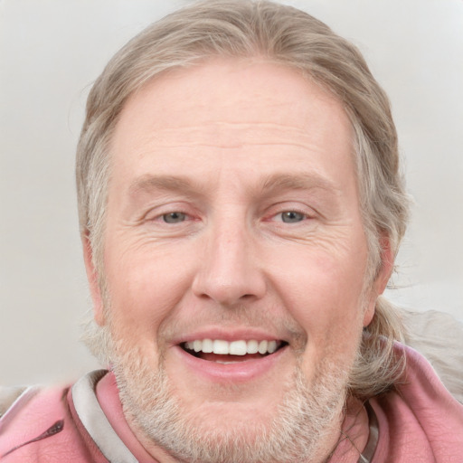 Joyful white adult male with short  brown hair and blue eyes