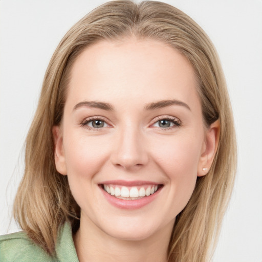 Joyful white young-adult female with long  brown hair and blue eyes