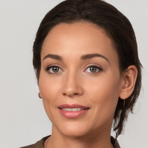 Joyful white young-adult female with medium  brown hair and brown eyes