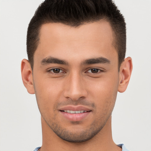 Joyful white young-adult male with short  brown hair and brown eyes