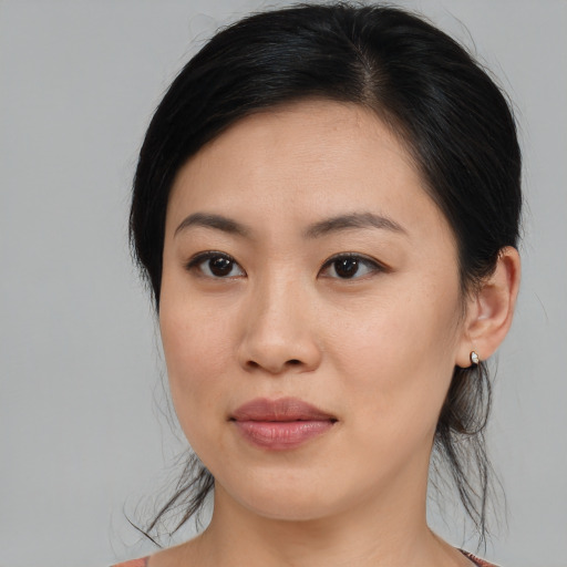 Joyful asian young-adult female with medium  brown hair and brown eyes