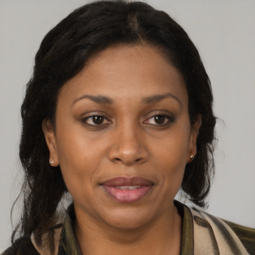 Joyful black adult female with medium  brown hair and brown eyes
