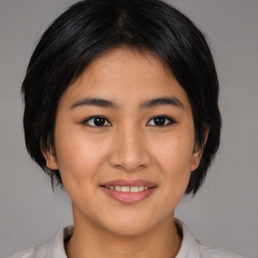 Joyful asian young-adult female with medium  black hair and brown eyes
