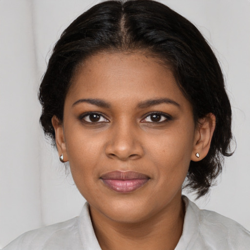 Joyful black young-adult female with medium  brown hair and brown eyes