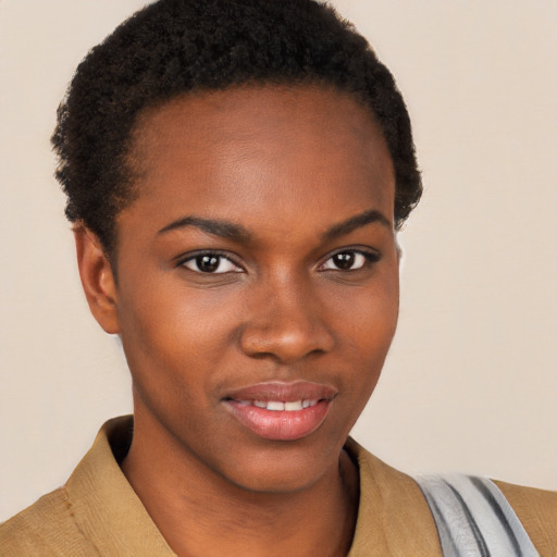 Joyful black young-adult female with short  brown hair and brown eyes