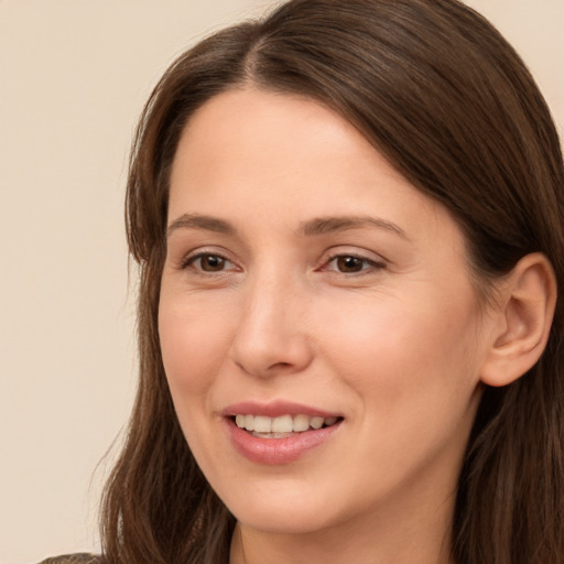 Joyful white young-adult female with long  brown hair and brown eyes