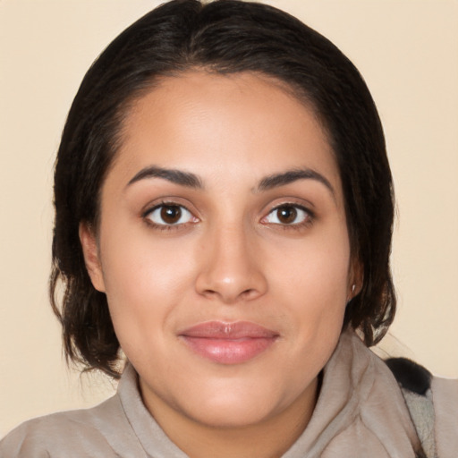 Joyful latino young-adult female with medium  brown hair and brown eyes